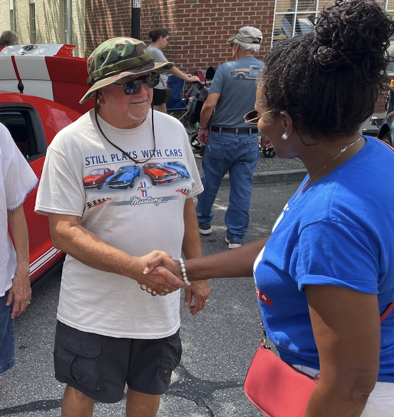 Trish talking with neighbors at a local car show