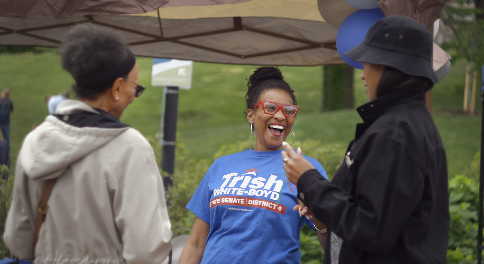 Trish talking with neighbors at a community event